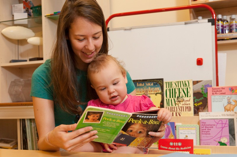 A mother and child enjoy reading together at the University of Delaware.