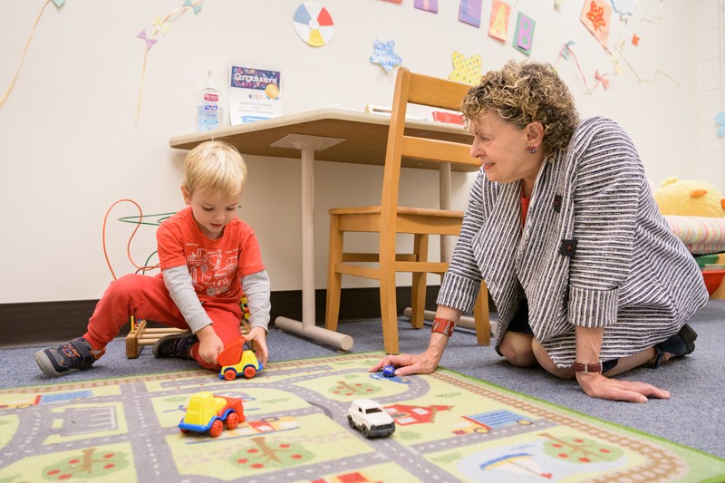 Roberta Michnick Golinkoff (right), Unidel H. Rodney Sharp Professor in the School of Education at the University of Delaware, meets with a child before his participation in learning experiments at the Child’s Play, Learning and Development Laboratory.