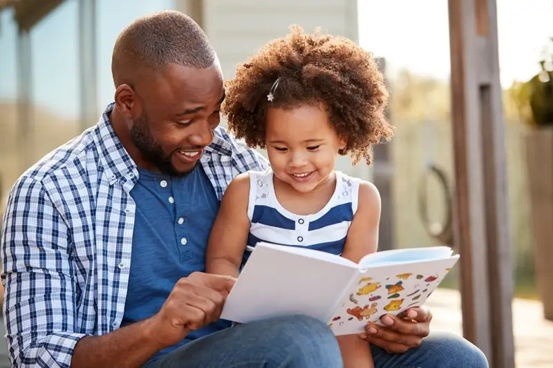 An adult reading to a child